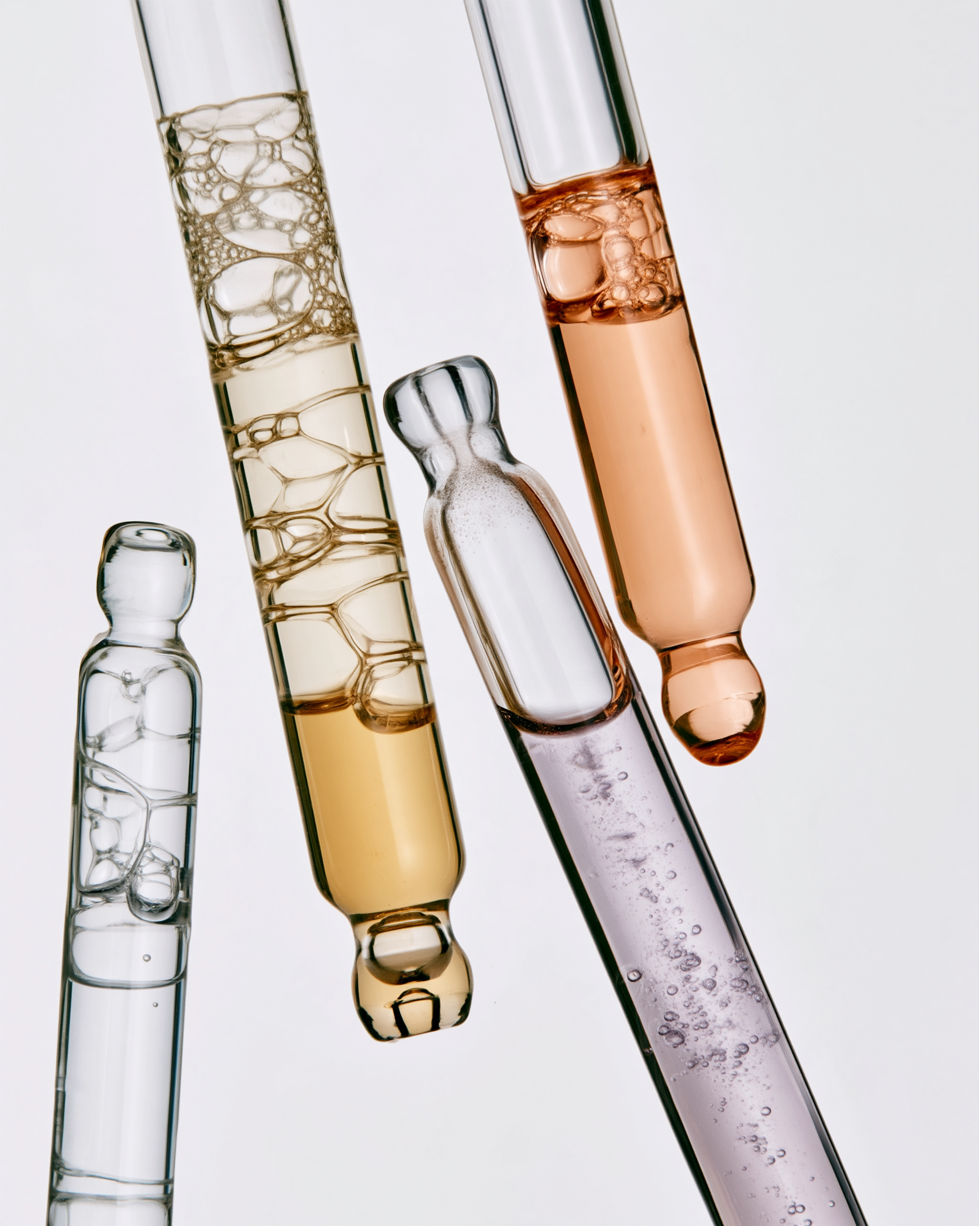 Four_elegant_cosmetic_glass_dropper_pipettes_arranged_togethe_56092ce7-7ecf-406d-b68c-2c4e941cb35e_1